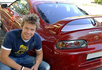 Todd Lasance poses with his red color Toyota.